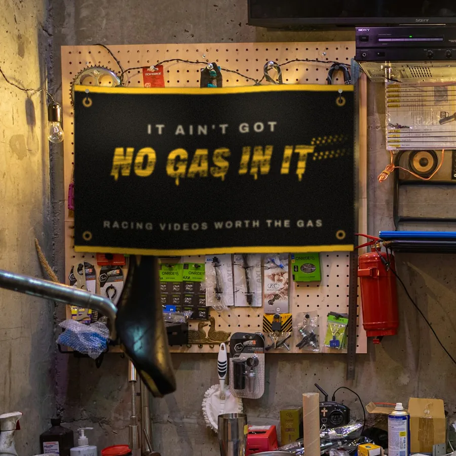 Black It Ain't Got No Gas In It banner hanging on a workshop pegboard